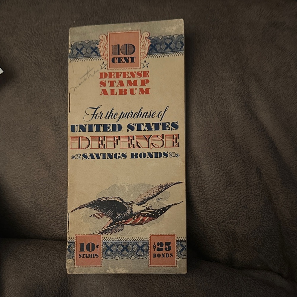 Vintage Defense Stamp Album from WW2 with 4 stamps